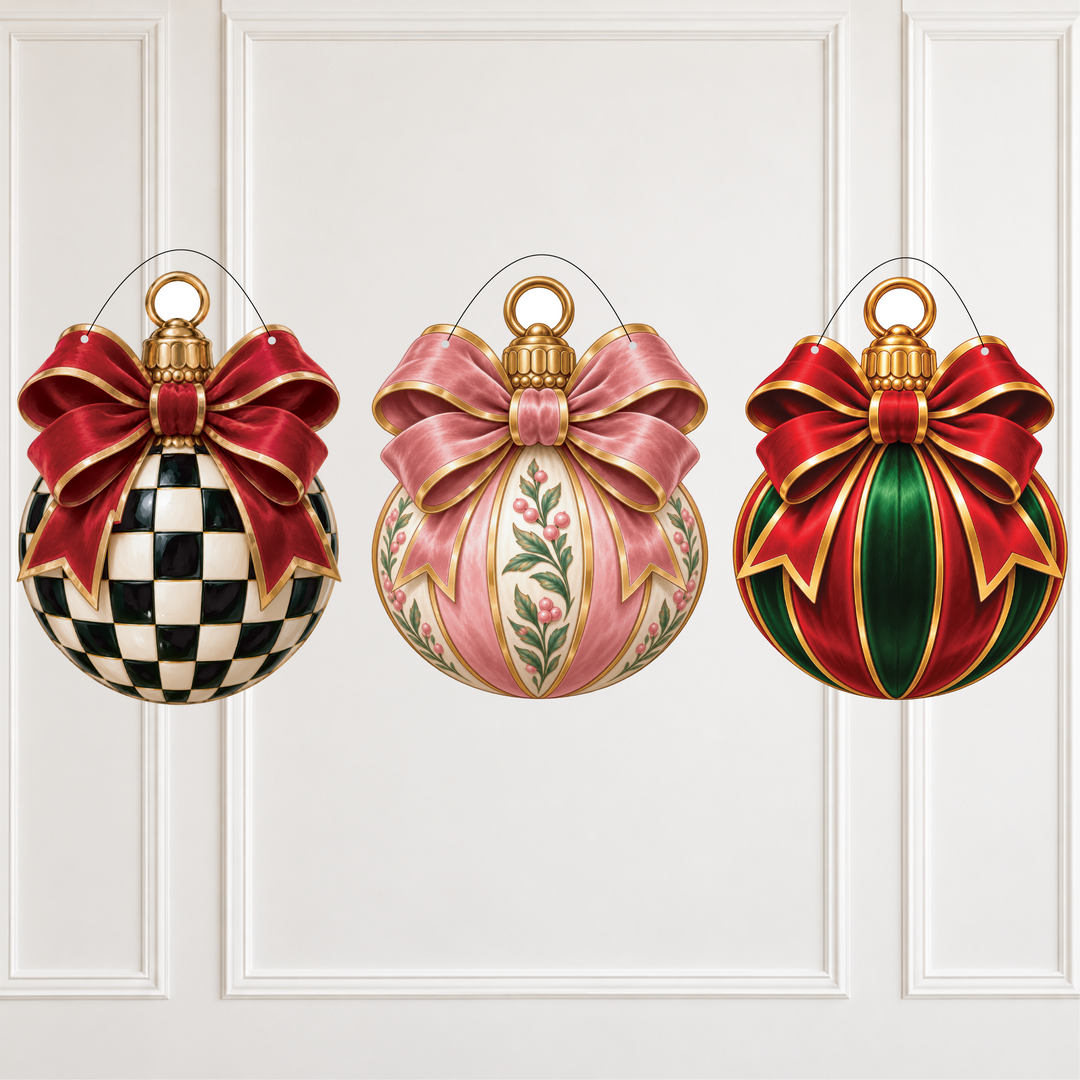 Three decorative Christmas ornaments hanging against a white paneled wall. The left ornament is round with a black-and-white checkerboard pattern and a large red bow with gold trim.
