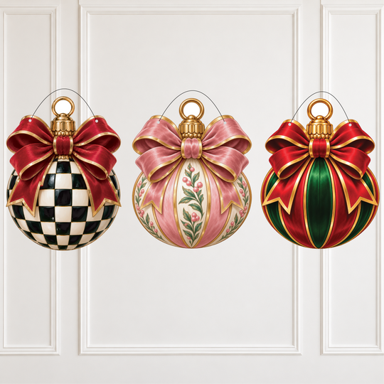 Three decorative Christmas ornaments hanging against a white paneled wall. The left ornament is round with a black-and-white checkerboard pattern and a large red bow with gold trim.