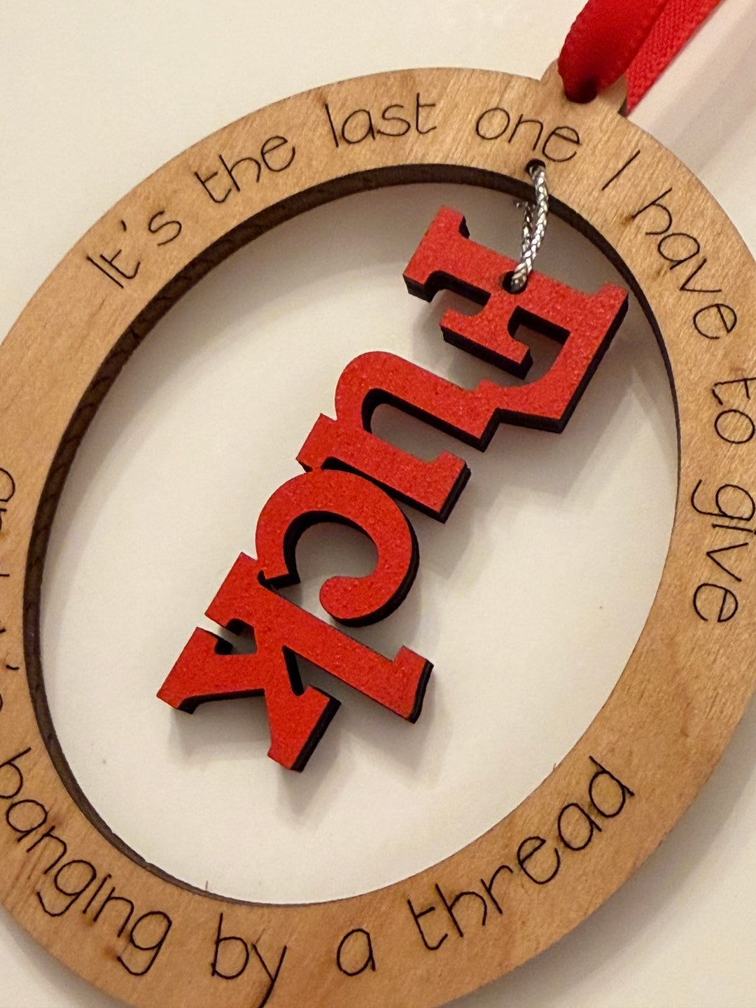 “Hanging by a Thread” Funny Ornament