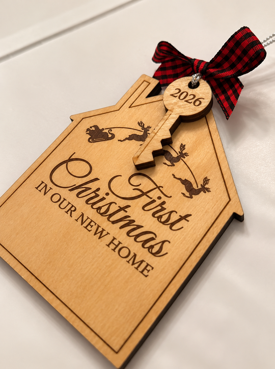 A personalized wooden house-shaped ornament with a key-shaped tag, engraved with &