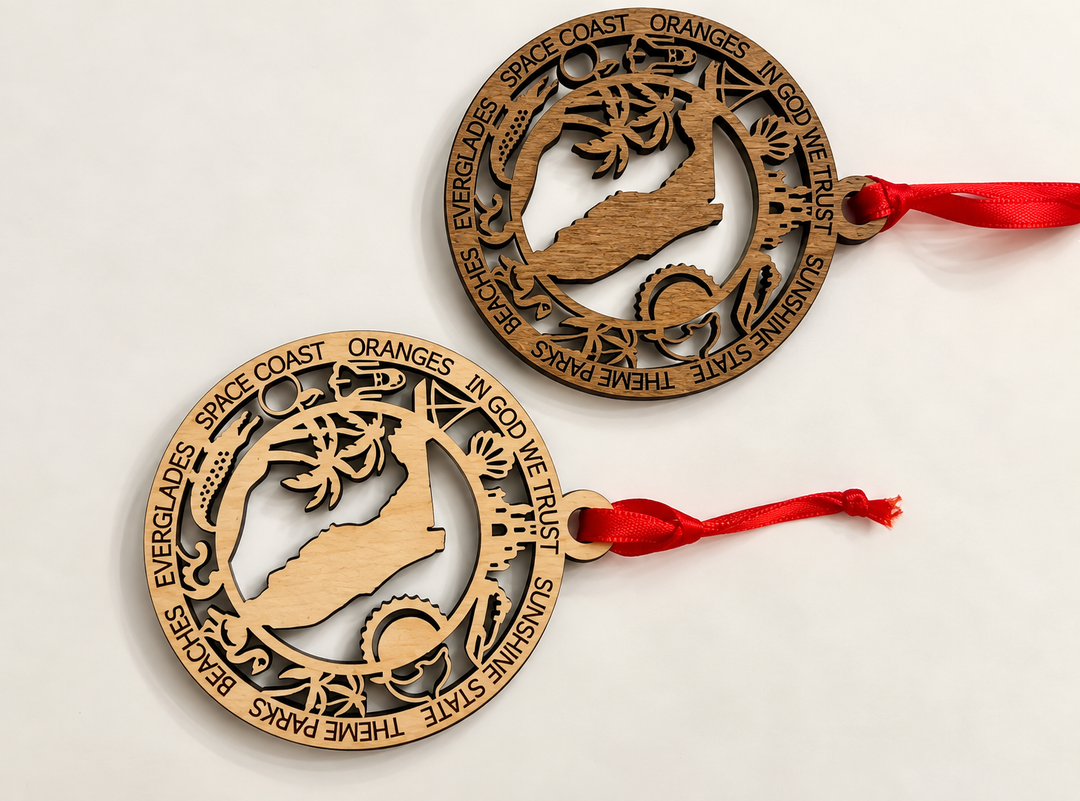 Two round laser-cut wooden ornaments featuring a silhouette of Orange, California, with surrounding text including &