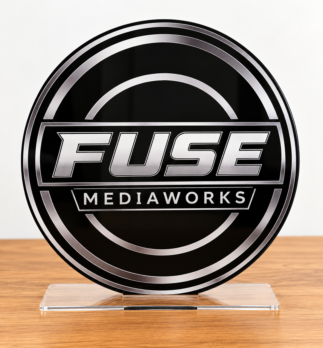 A round black and silver plaque featuring the text &