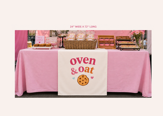 Table with pink tablecloth and &