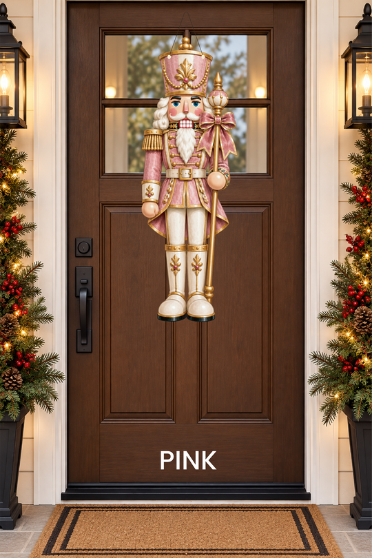 A pink nutcracker door hanger on a door